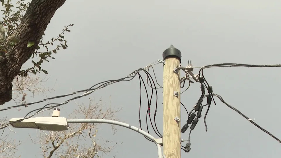 <div>Traditional overhead power lines stretch across a utility pole, illustrating the older style of electrical distribution that requires public clearance.</div>