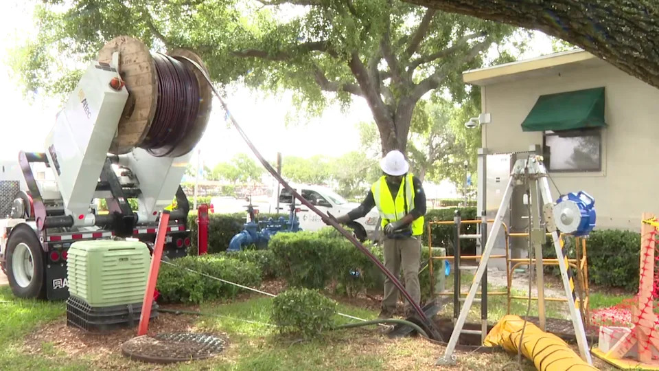 <div>Thick insulated power cables are fed directly into an underground utility access point beneath the city streets.</div>