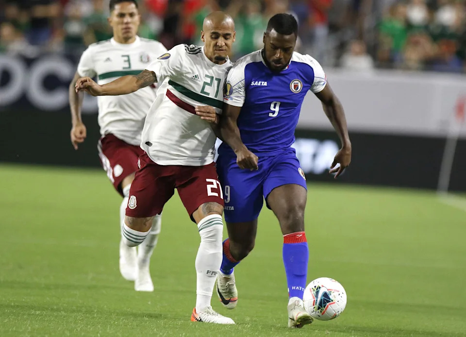 Mexico's Luis Rodriguez (21) and Haiti's Duckens Nazon (9) battle for the ball during the first half of their Concacaf Gold Cup match at State Farm Stadium in Glendale July 2, 2019.