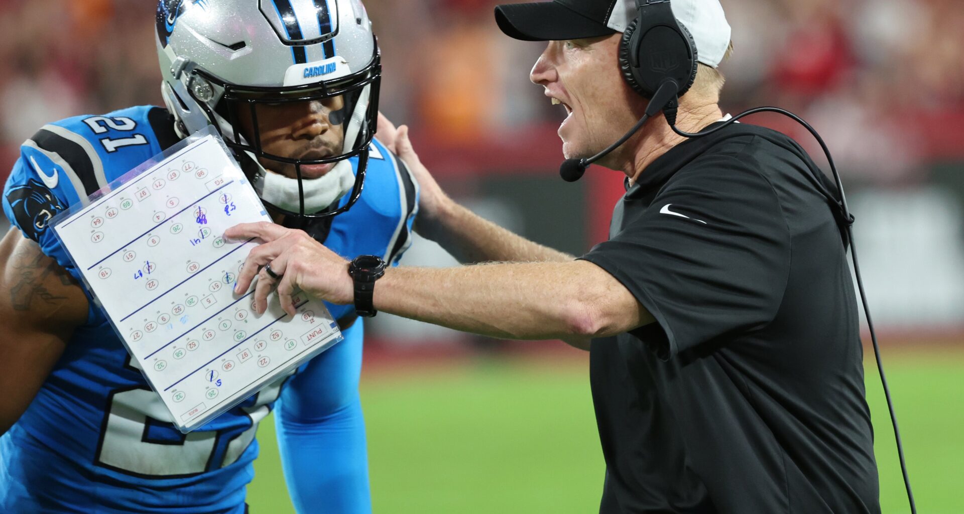 Dec 3, 2023; Tampa, Florida, USA; Carolina Panthers interim head coach Chris Tabor talks with safety Jeremy Chinn (21) against the Tampa Bay Buccaneers during the second half at Raymond James Stadium. Mandatory Credit: Kim Klement Neitzel-USA TODAY Sports