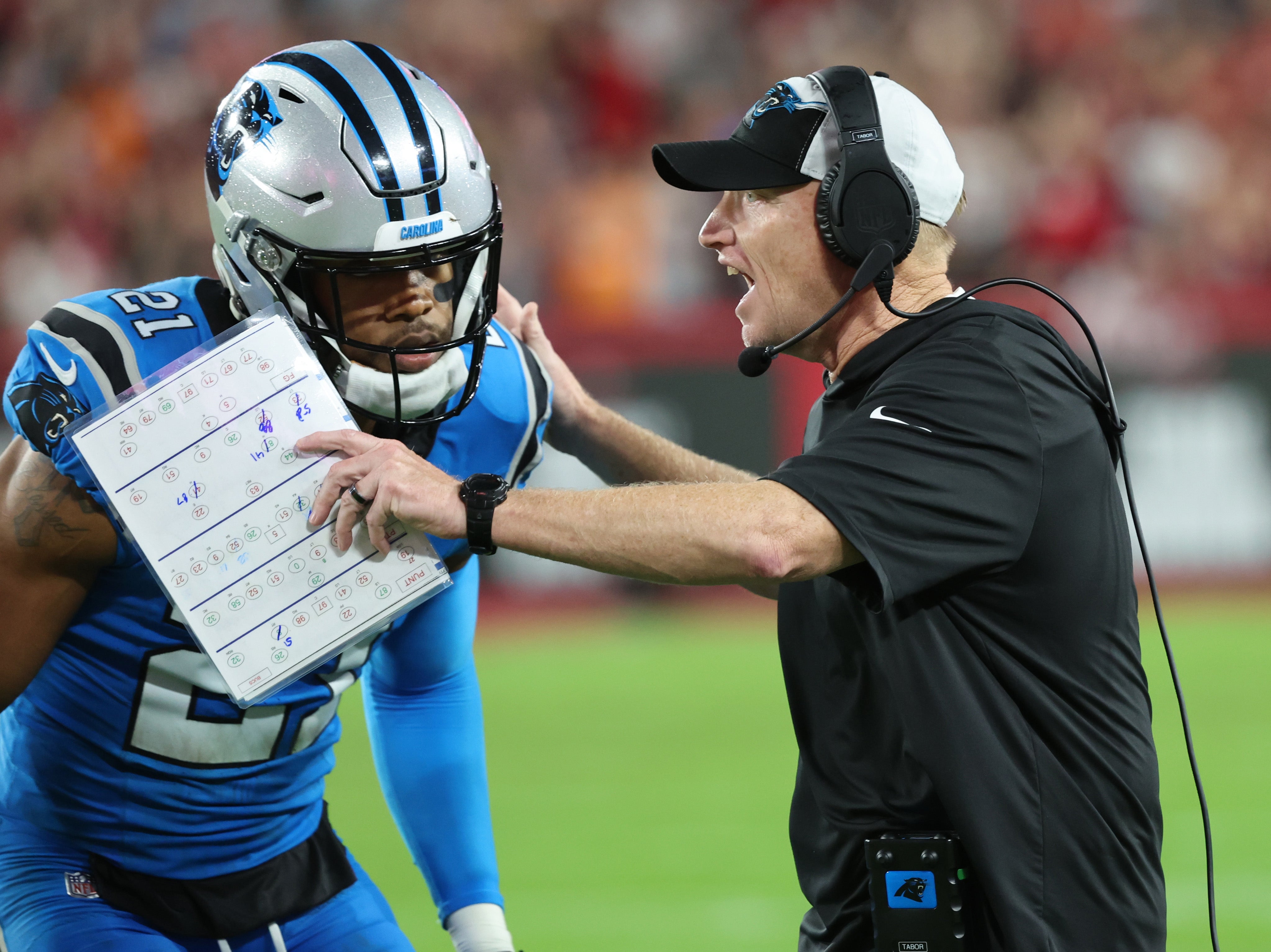 Dec 3, 2023; Tampa, Florida, USA; Carolina Panthers interim head coach Chris Tabor talks with safety Jeremy Chinn (21) against the Tampa Bay Buccaneers during the second half at Raymond James Stadium. Mandatory Credit: Kim Klement Neitzel-USA TODAY Sports