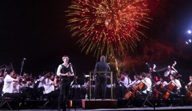 Photo of an orchestra performing in Miami Beach in front of Fire works