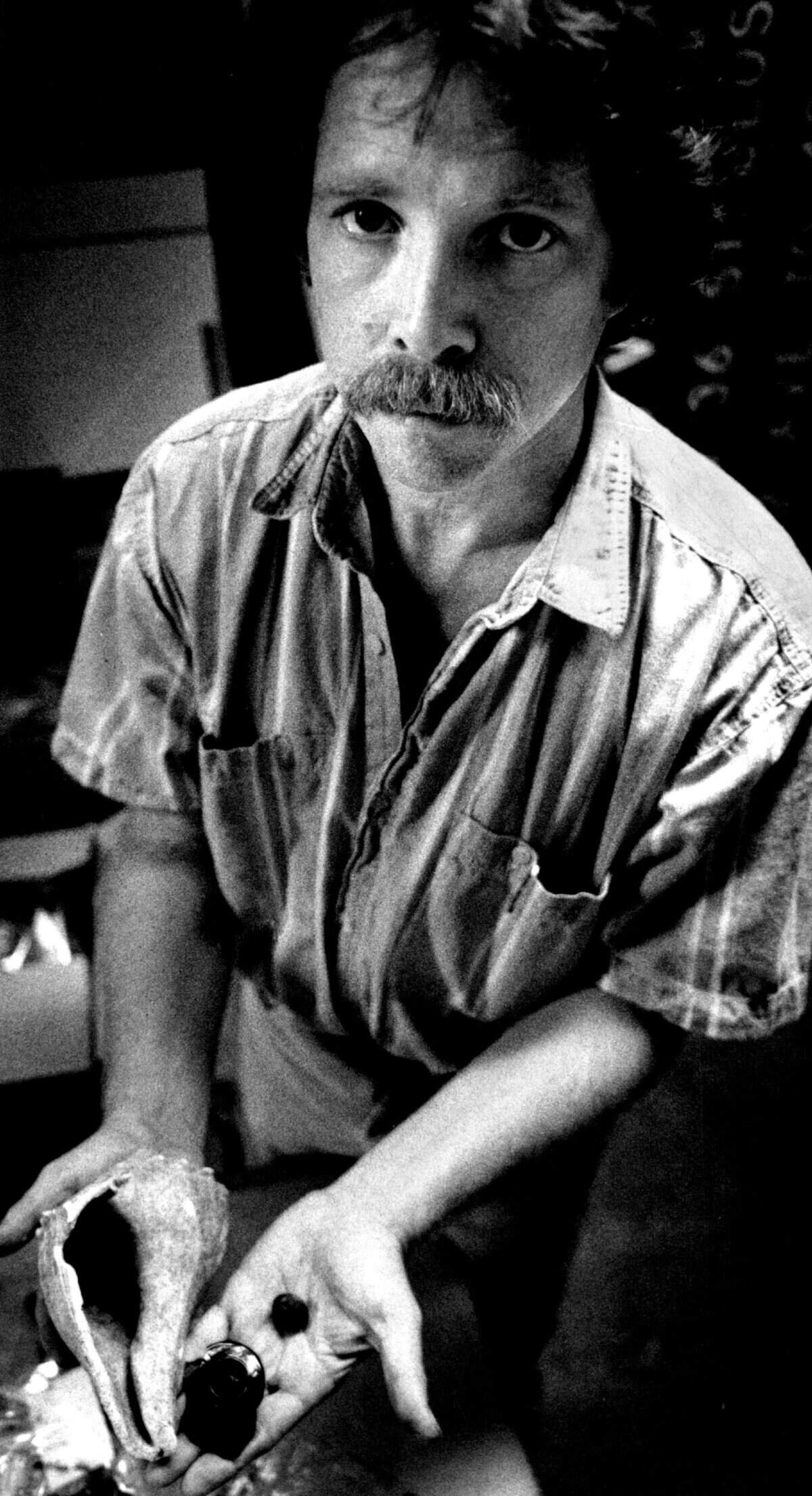 A Miami Herald photo from 1988 shows archaeologist Bob Carr holding some of the artifacts found in an archeological site near what was then called Joe Robbie Stadium, now Hard Rock Stadium, which include a shell used by Tequesta Indians as a tool, a U.S. Army officer’s jacket button from the Seminole Indian War period and the top of a 150-year-old bottle.