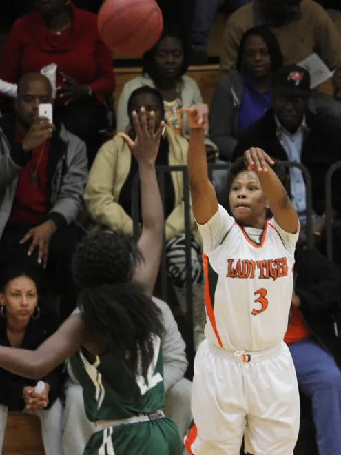 Dunbar's Keri Jewett shoots a 3-pointer over Tampa Catholic's Mia Blocker during the Region 4A-3 girls basketball championship game at Dunbar High School on Friday night.