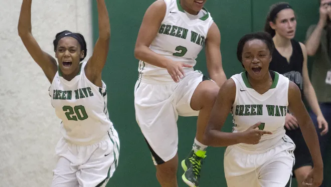 Larissa Roker, Jarya Outten and Bethany Brunson of Fort Myers celebrate their win over Lakewood Ranch in the girls regional basketball finals on Saturday, February 14, 2015, at Fort Myers High School.