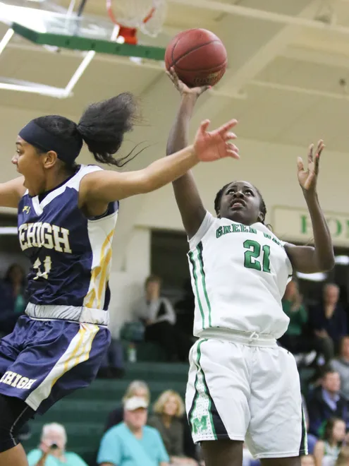 Fort Myers' Autumn Giles (21) shoots against Leigh's Halley Holloway (11) during the ladies basketball game at Fort Myers High School in Fort Myers, FL on Friday, January 29, 2016.  Fort Myers defeated Lehigh to win the Deistrict 6A-11 Championship.  Photo by Gregg Pachkowski