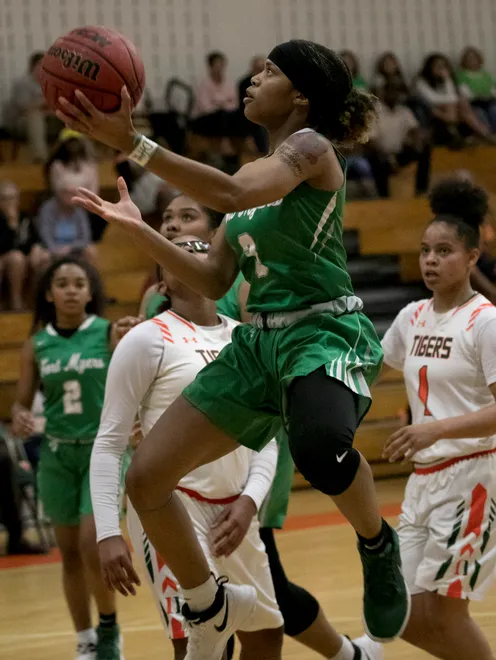 Destanni Henderson of Fort Myers takes a shot against Dunbar in the girls basketball district championship on Friday, Feb. 9, 2018, in Fort Myers.