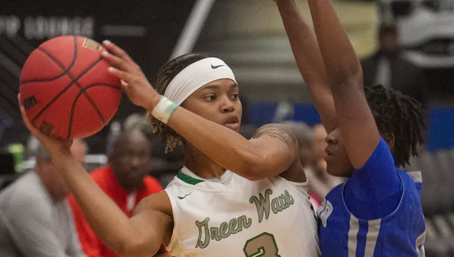 Fort Myers High School's Destanni Henderson looks to pass under pressure from Dillard High School's Kayla Burrows during the second half of their FHSAA Girls 7A Semifinal game at The RP Funding Center in Lakeland Friday.