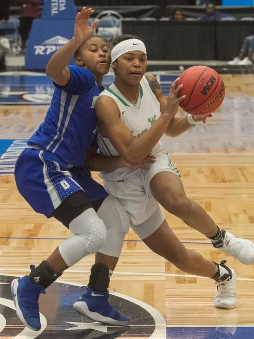 Fort Myers High School's Destanni Henderson (3) drives towards the basket as Dillard High School's Briah Christia (4) tries to defend during the first half of their FHSAA Girls 7A Semifinal game at The RP Funding Center in Lakeland Friday.
