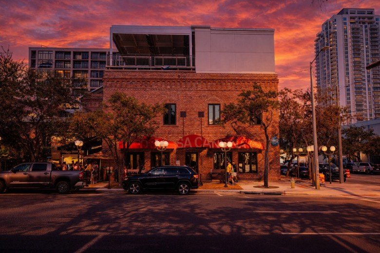 Red Mesa Cantina restaurant in downtown St. Petersburg, Florida at sunset, featuring its historic brick facade and rooftop patio.