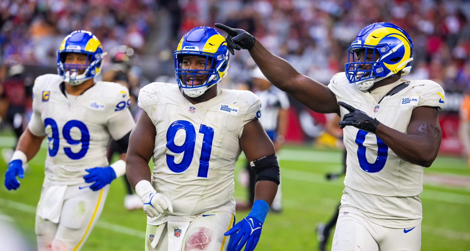 Nov 26, 2023; Glendale, Arizona, USA; Los Angeles Rams defensive tackle Kobie Turner (91) with linebacker Byron Young (0) and defensive tackle Aaron Donald (99) against the Arizona Cardinals at State Farm Stadium. Mandatory Credit: Mark J. Rebilas-USA TODAY Sports