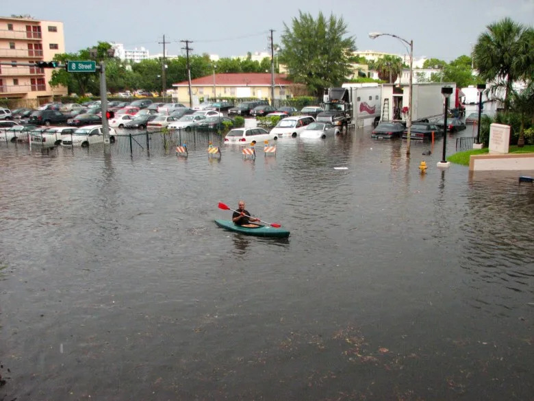 A kayak in the streets of Miami in 2009 after there were several inches of rain, which coincided with tidal effects and a lack of drainage. (maxstrz on Flickr via Wikimedia Commons)
