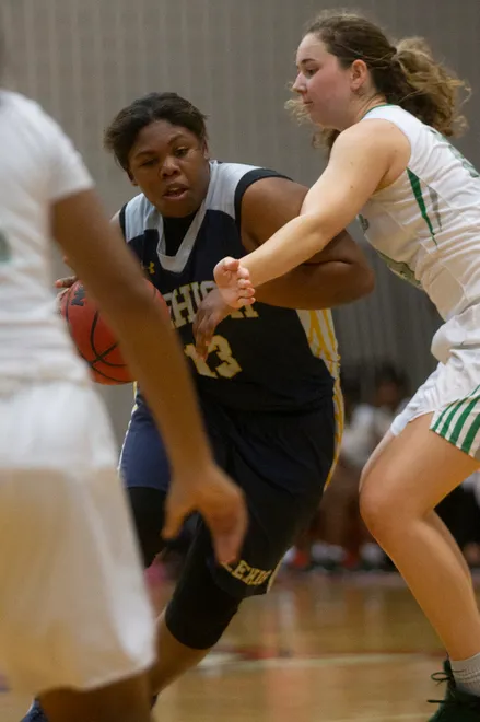Lehigh's Aleisha Curry dribbles the ball while defended by Fort Myers' Riley Ludlam, Friday, Feb. 8, 2019, at Dunbar High School in Fort Myers.