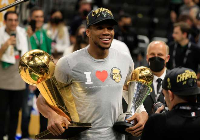 2021 NBA Finals - Game Six MILWAUKEE, WISCONSIN - JULY 20: Giannis Antetokounmpo #34 of the Milwaukee Bucks holds the Bill Russell NBA Finals MVP Award and the Larry O'Brien Championship Trophy after defeating the Phoenix Suns in Game Six to win the 2021 NBA Finals at Fiserv Forum on July 20, 2021 in Milwaukee, Wisconsin. NOTE TO USER: User expressly acknowledges and agrees that, by downloading and or using this photograph, User is consenting to the terms and conditions of the Getty Images License Agreement. (Photo by Justin Casterline/Getty Images)