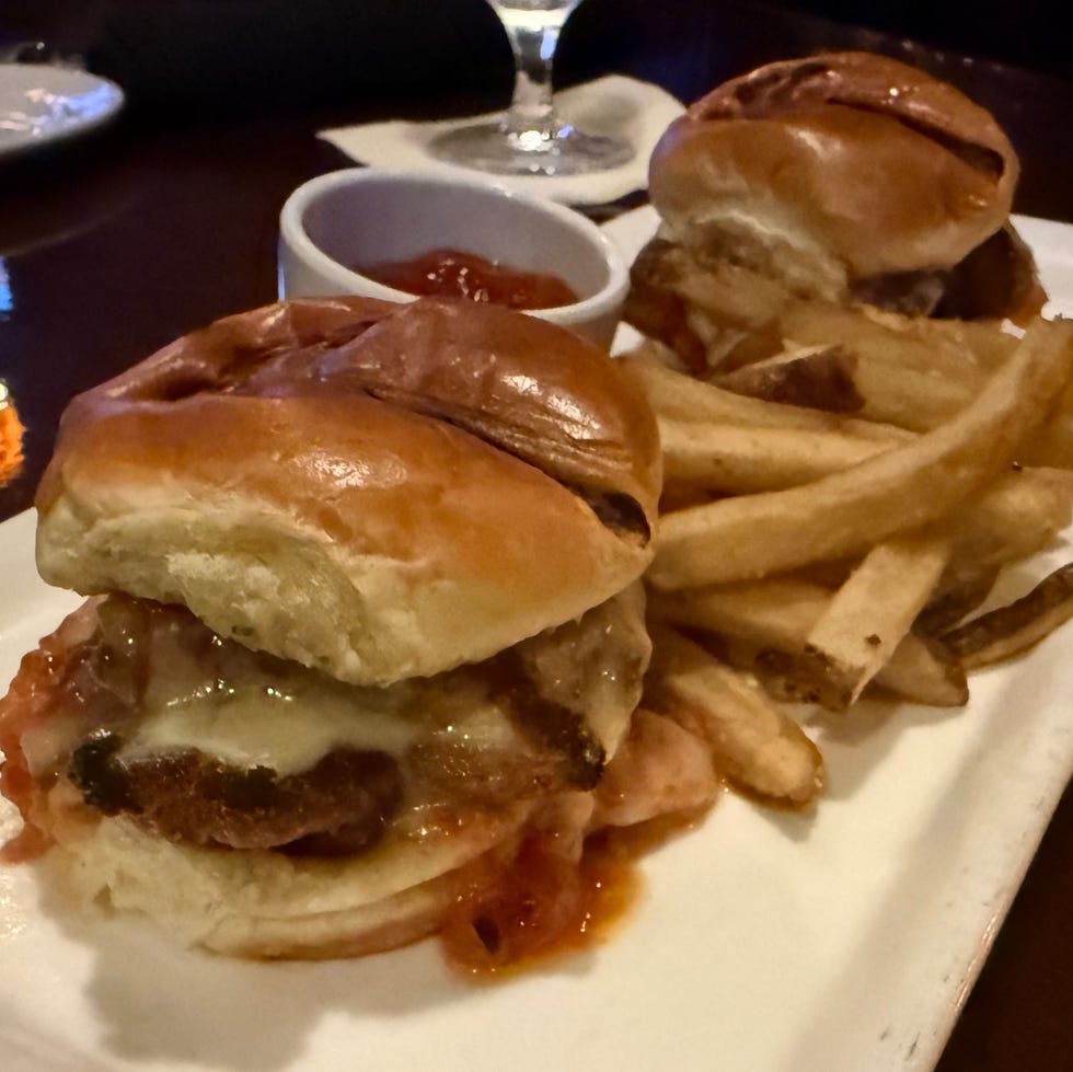 Sliders and fries on a rectangular plate with a side of ketchup Sliders and fries on a rectangular plate with a side of ketchup