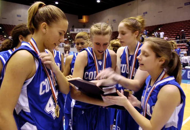 From left, Barron Collier's Kacey Will, Courtney Jacob, Kelsey Assarian, and Allyson Naretta, look over the Class 5A State Championship trophy after Barron Collier defeated Winter Haven 43-36 in Lakeland on Friday, Feb. 24, 2006.