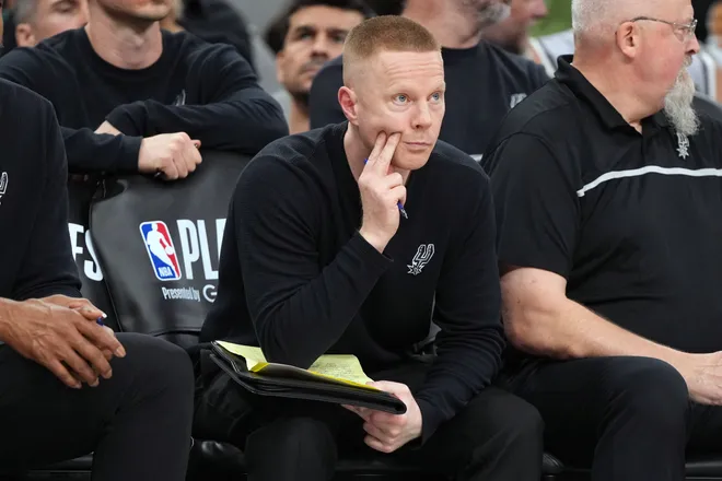 May 12, 2026; San Antonio, Texas, USA; San Antonio Spurs assistant head coach Sean Sweeney observes the second half of play during game five of the second round of the 2026 NBA Playoffs against the Minnesota Timberwolves at Frost Bank Center. Mandatory Credit: Scott Wachter-Imagn Images
