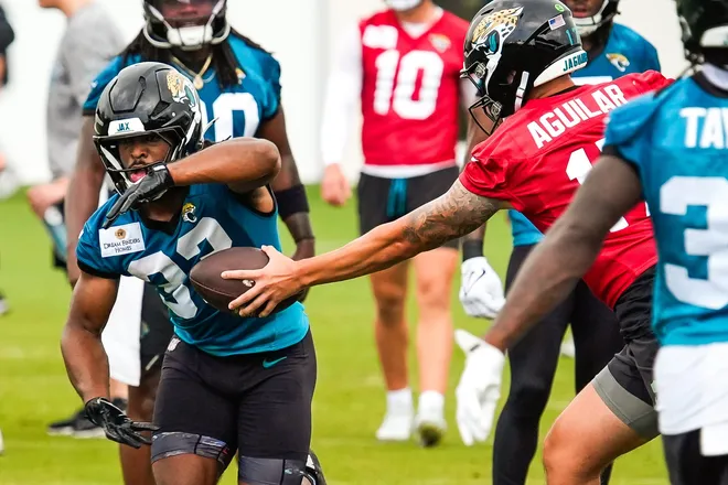 Jacksonville Jaguars running back Bhayshul Tuten (33) takes a hand off from Jacksonville Jaguars quarterback Joey Aguilar (17) during the second day of minicamp at the Miller Electric Center, Wednesday, June 10, 2026, in Jacksonville. [Doug Engle/Florida Times-Union]