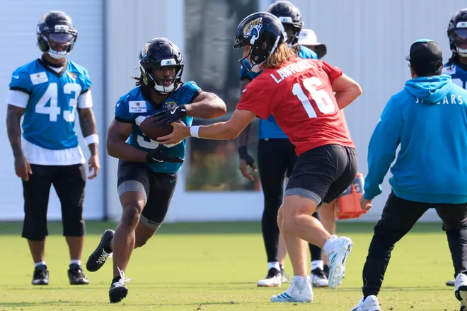 Jacksonville Jaguars quarterback Trevor Lawrence (16) hands off to running back Bhayshul Tuten (33) during the third day of minicamp at the Miller Electric Center, Thursday, June 11, 2026, in Jacksonville, Fla.