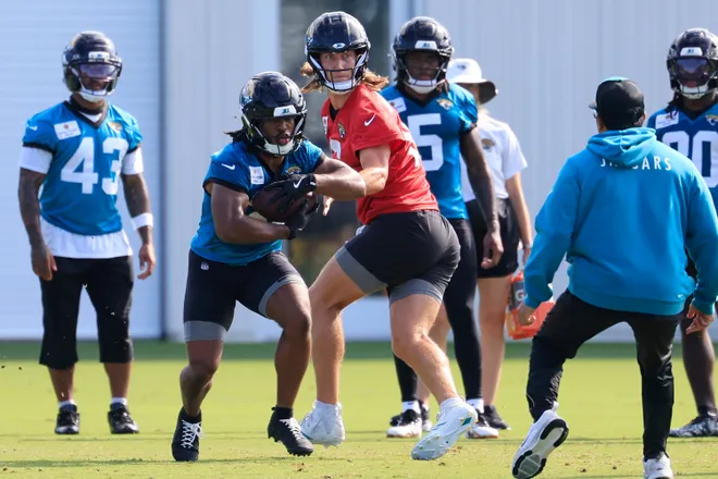 Jacksonville Jaguars quarterback Trevor Lawrence (16) hands off to running back Bhayshul Tuten (33) during the third day of minicamp at the Miller Electric Center, Thursday, June 11, 2026, in Jacksonville, Fla.