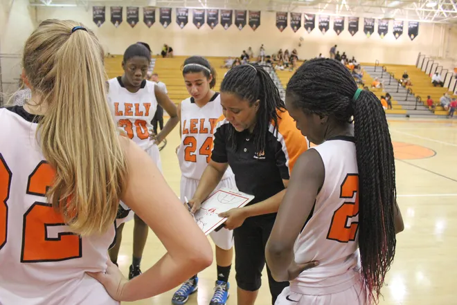 Lely coach Kirsti Jones draws up a play during a timeout in the Lady Trojans win over Palmetto Ridge on Jan. 14, 2013.