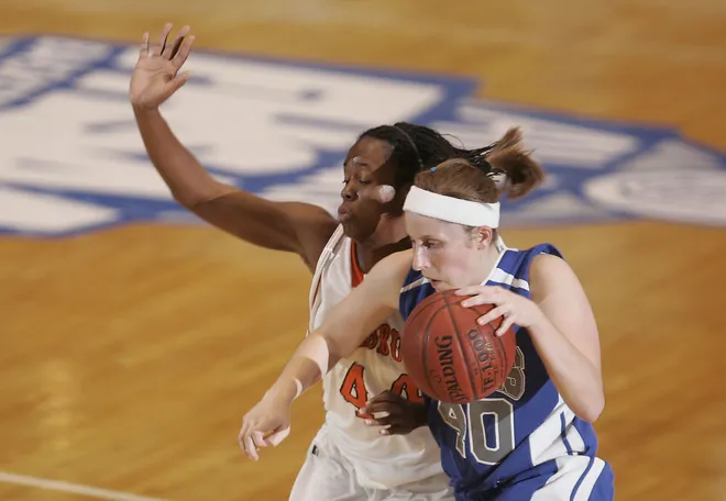 Barron Collier's Kelsey Assarian drives on Leesburg's Tenia Manuel in the Class 5A girls basketball state semifinal at the Lakeland Center on Wednesday February 20, 2008.