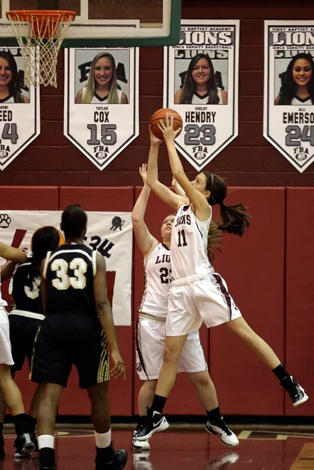First Baptist Academy freshman Emily Lines, the daughter of coach Jennifer Lines, rebounds against Golden Gate High School during a basketball game Thursday in the FBA gym. Before Thursday's game, Emily Lines was honored for scoring 1000 career points for FBA.