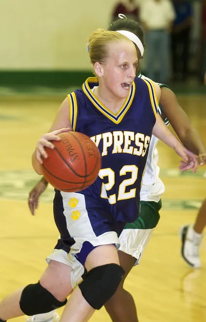 Cypress Lake's Ashley Traugott (22) drives past Fort Myers' Fatima Williams to score on Tuesday, Jan. 27, 2004 at Fort Myers High School.
