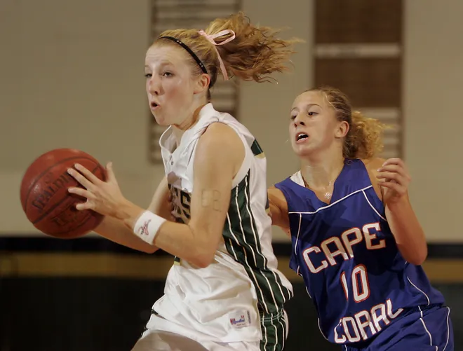 St John Neumann's Sarah Wickham, left, drives past Cape Coral's Alexiss Griffin during a recent
game in Naples on Thursday Nov. 15, 2007.
