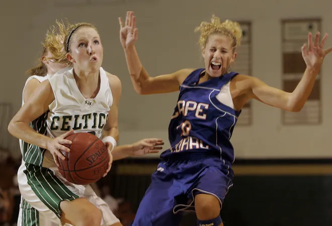 St John Neumann's Sarah Wickham, left, drives past Cape Coral's Alexiss Griffin during a recent
game in Naples on Thursday Nov. 15, 2007.