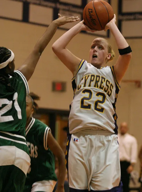 Cypress Lake's Ashley Traugott takes a shot over Fort Myers' Fatima Williams on Saturday, February 14, 2004, at Cypress Lake High School.