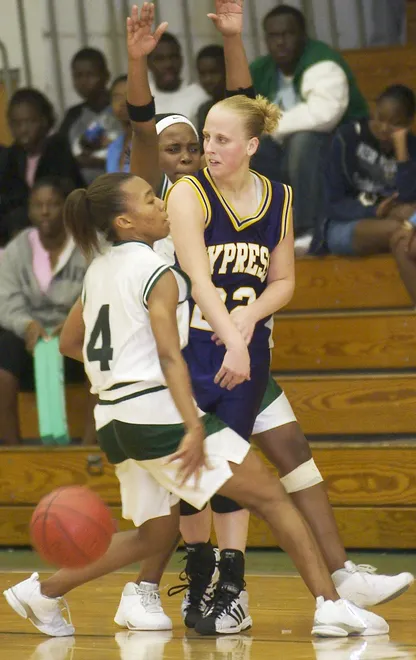 Cypress Lake's Ashley Traugott, right, passes out of a Fort Myers double team on Tuesday, Jan. 27, 2004 at Fort Myers High School.