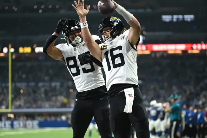Dec 28, 2025; Indianapolis, Indiana, USA; Jacksonville Jaguars quarterback Trevor Lawrence (16) celebrates with tight end Brenton Strange (85) after a touchdown against the Indianapolis Colts during the first half at Lucas Oil Stadium. Mandatory Credit: Robert Goddin-Imagn Images