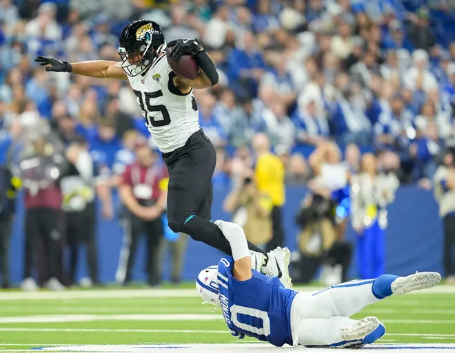 Jacksonville Jaguars tight end Brenton Strange (85) is brought down Indianapolis Colts safety Camryn Bynum (0) on Sunday, Dec. 28, 2025, during a game at Lucas Oil Stadium in Indianapolis.