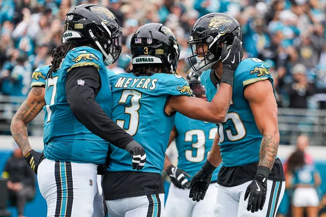 Jacksonville Jaguars tight end Brenton Strange (85) is congratulated by Jacksonville Jaguars wide receiver Jakobi Meyers (3) after scoring a touchdown during the second quarter in an NFL football matchup at EverBank Stadium, Sunday, Jan. 4, 2026, in Jacksonville, Fla. [Doug Engle/Florida Times-Union]