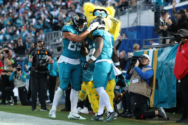 Jan 11, 2026; Jacksonville, FL, USA; Jacksonville Jaguars running back Travis Etienne Jr. (1) reacts with tight end Brenton Strange (85) after he scored a touchdown during the second half against the Buffalo Bills in an AFC Wild Card Round game at EverBank Stadium. Mandatory Credit: Nathan Ray Seebeck-Imagn Images