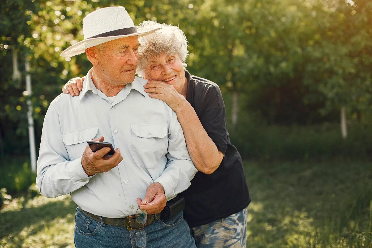 An elderly couple is seen in a summer garden. (GDA via AP Images)