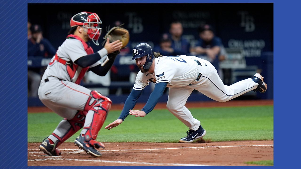 Tampa Bay Rays' Ryan Vilade, right, scores ahead of the throw to Boston Red Sox catcher Mickey Gasper on an RBI single by Cedric Mullins during the fourth inning of a baseball game Tuesday, June 9, 2026, in St. Petersburg, Fla. (AP Photo/Chris O'Meara)
