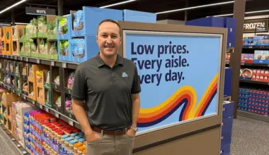 Aldi Regional Vice President JR Perry standing in front of a display case in the new Aldi store.