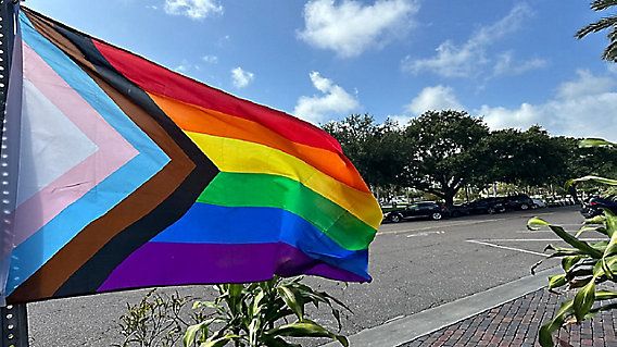 A pride flag blows in the wind outside of a restaurant on Beach Drive in downtown St. Pete. (Spectrum News/Angie Angers)