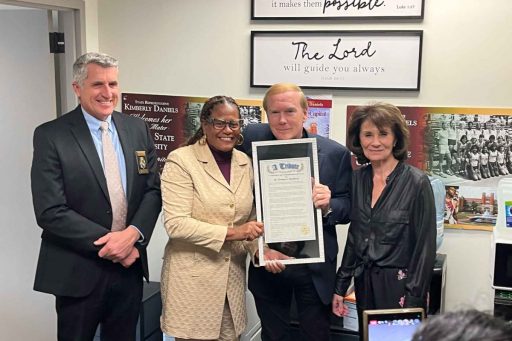 Florida Department of Law Enforcement Commissioner Mark Glass, Rep. Kimberly Daniels, Blomberg and Jeanine Blomberg pose for a photo while Blomberg holds his framed recognition.
