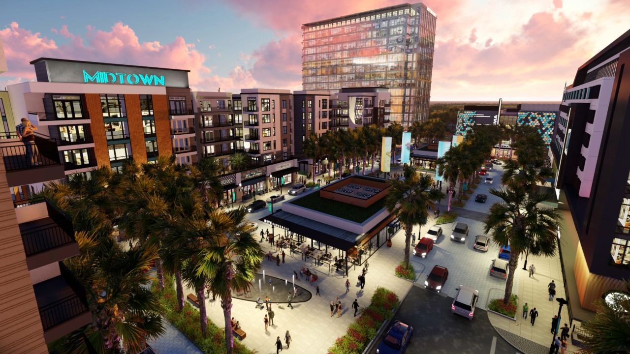 An aerial rendering of Midtown Tampa showing its mixed-use development with apartments, office buildings, retail space, restaurants and a central pedestrian plaza.
