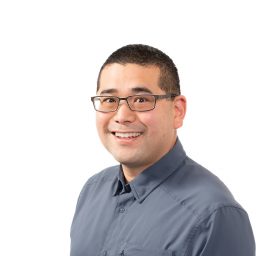 A headshot of Chris Uejio on a white background.