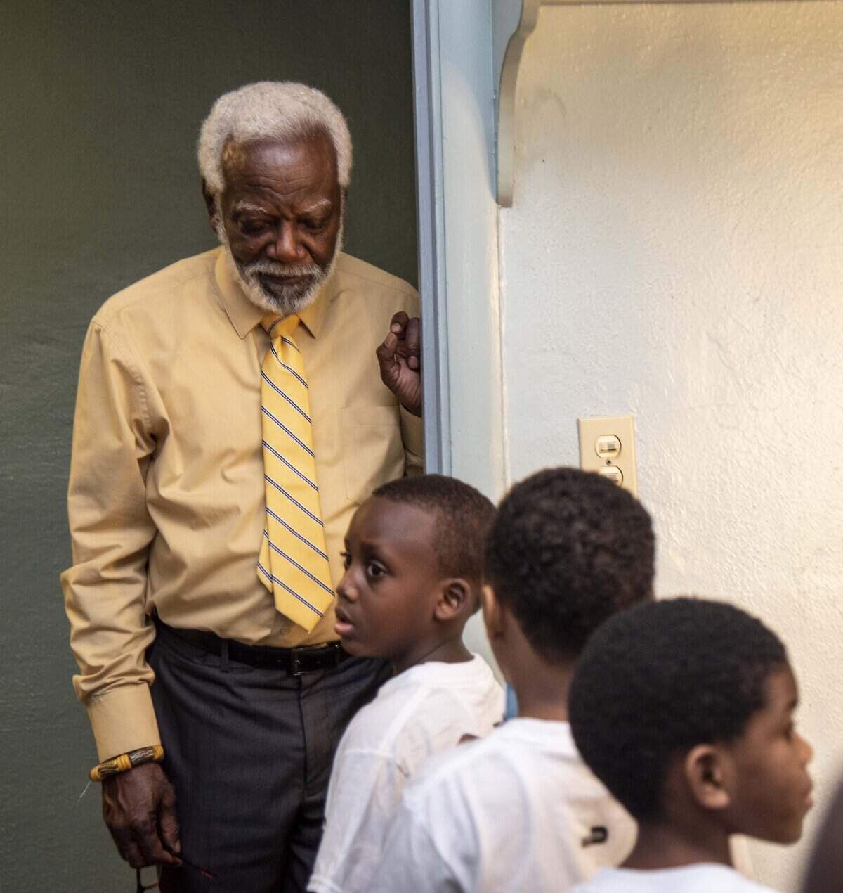 Marshall Davis Sr., director of the African Heritage Cultural Arts Center in Liberty City,  helps the 5-year-old class line up for a recorder performance.