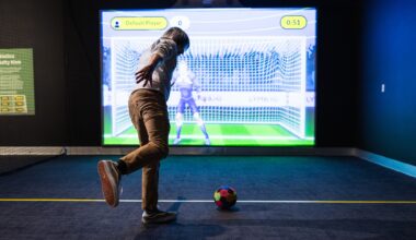 photo of a person kicking a soccer ball in front of an interactive screen showing an animated goalie in front of a soccer net