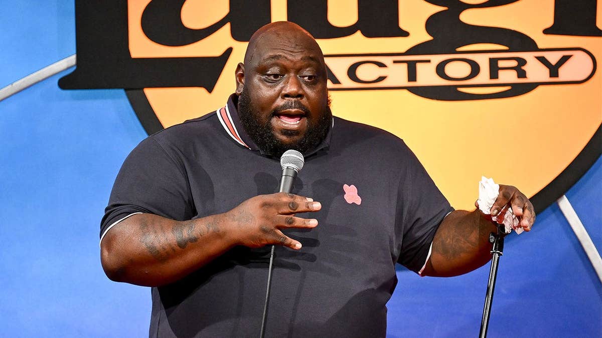 Faizon Love performs on stage before an audience at the Laugh Factory in Hollywood, California