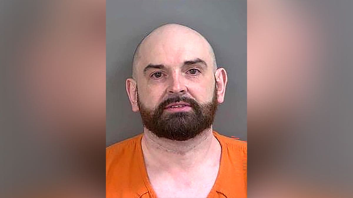 Booking photo of Floyd Stuck wearing an orange jail uniform.