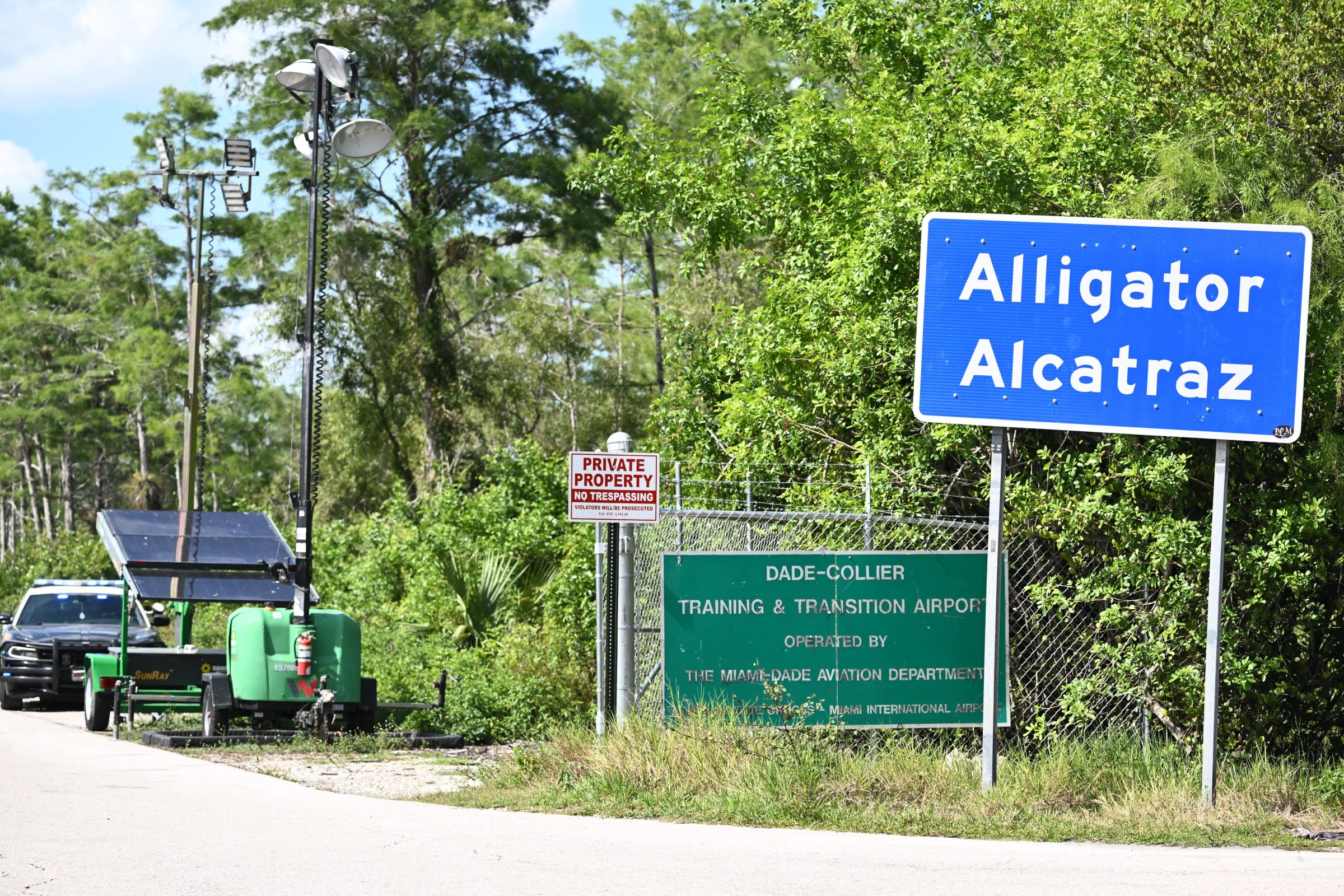 A Florida Highway Patrol car is seen at the entrance to the immigrant detention center known as “Alligator Alcatraz”