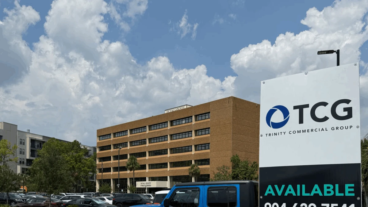 The Duval County Public Schools headquarters is shown in the background, with a TCG real estate sign in the foreground.