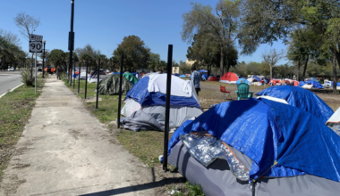 Homless tents lined up in a lot.